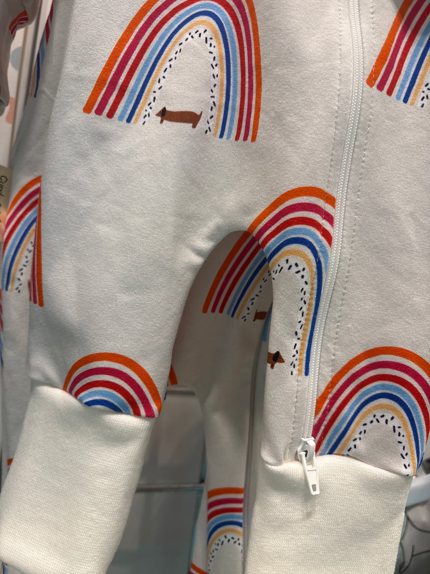 Sausage dog and rainbows zippy baby-grow