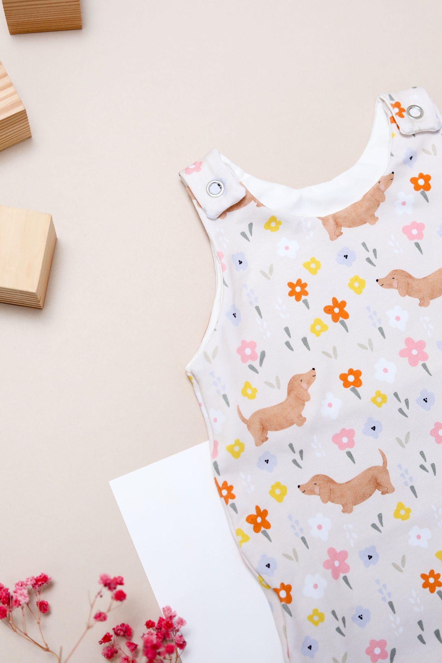 Flora sausage dog baby romper