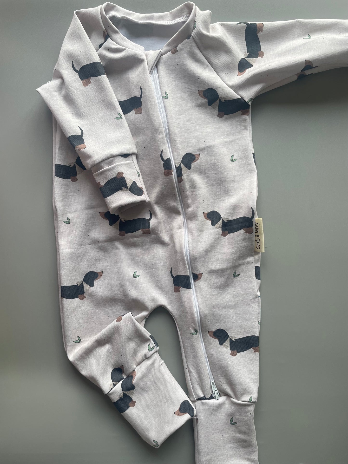 Eric Black and Tan sausage dog oatmeal zippy baby-grow