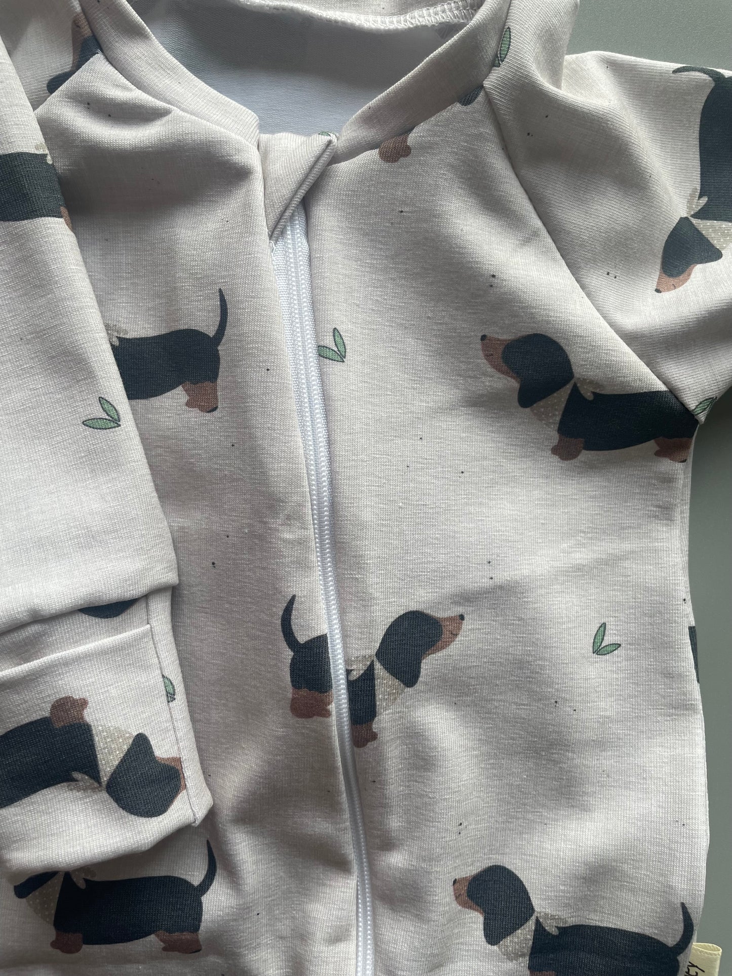 Eric Black and Tan sausage dog oatmeal zippy baby-grow