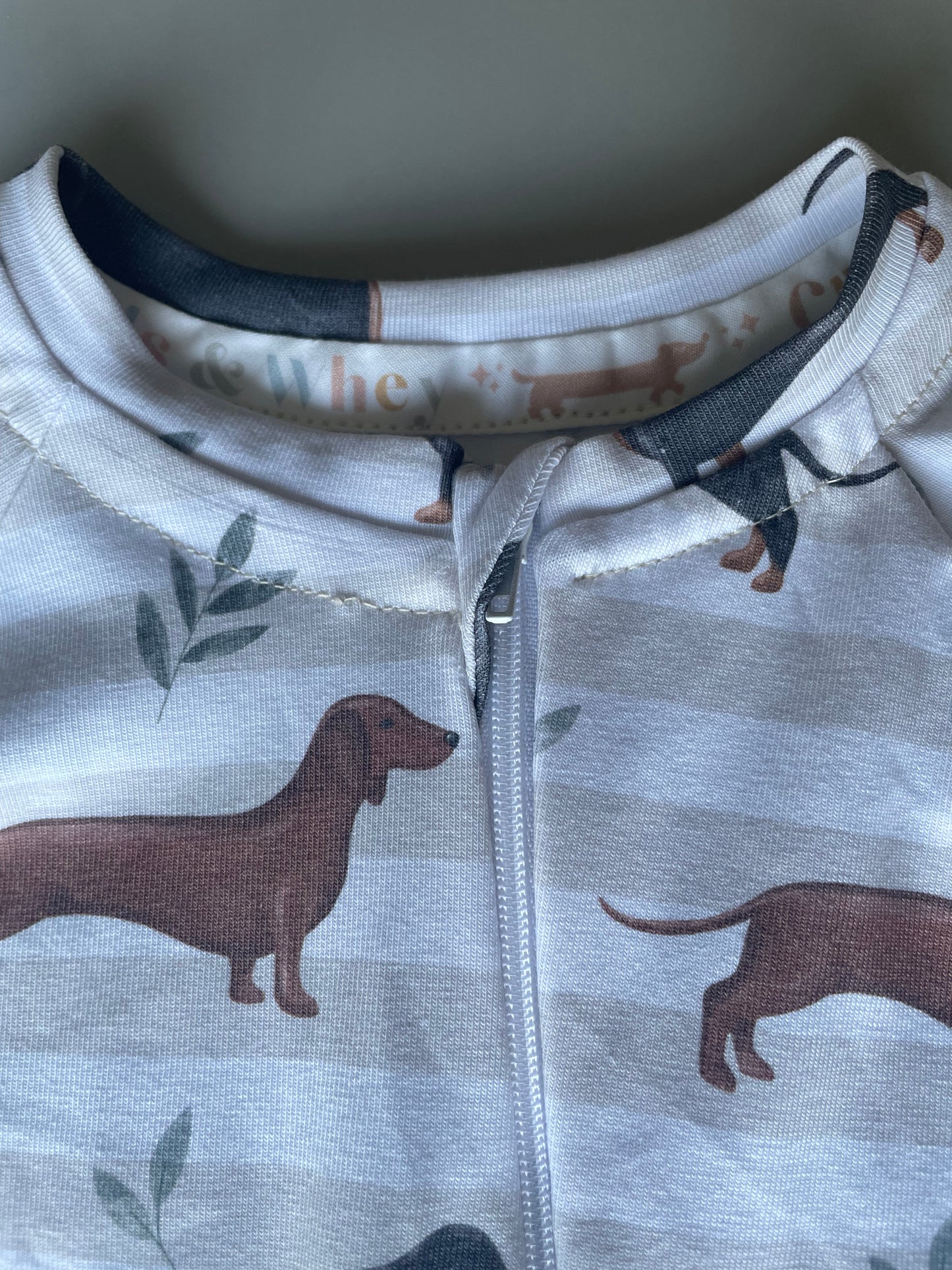 Neutral stripe sausage dog zippy baby-grow