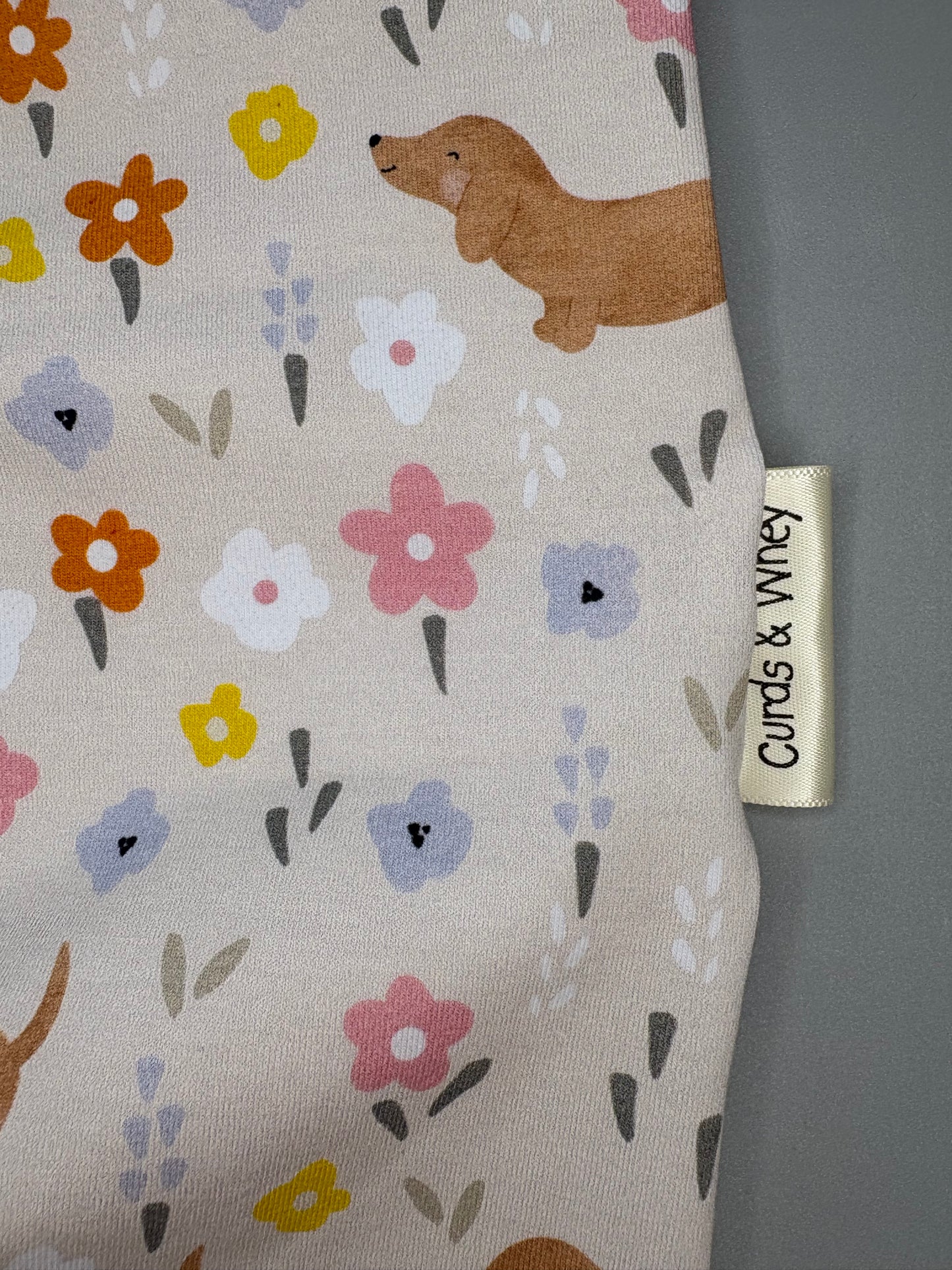 Flora sausage dog baby romper