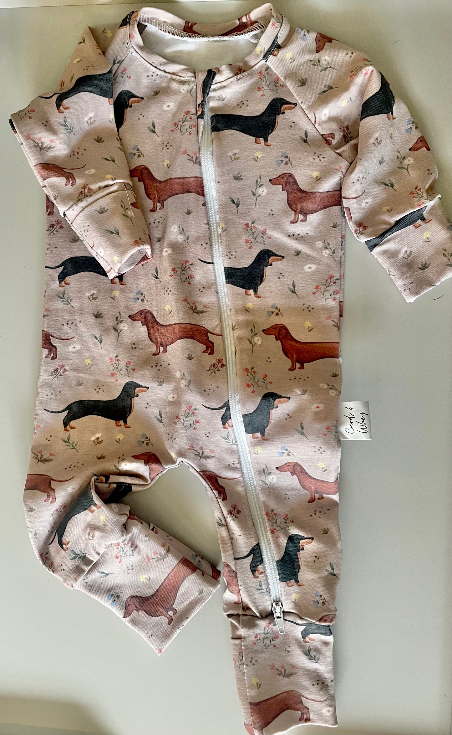 Florence sausage dog zippy baby-grow