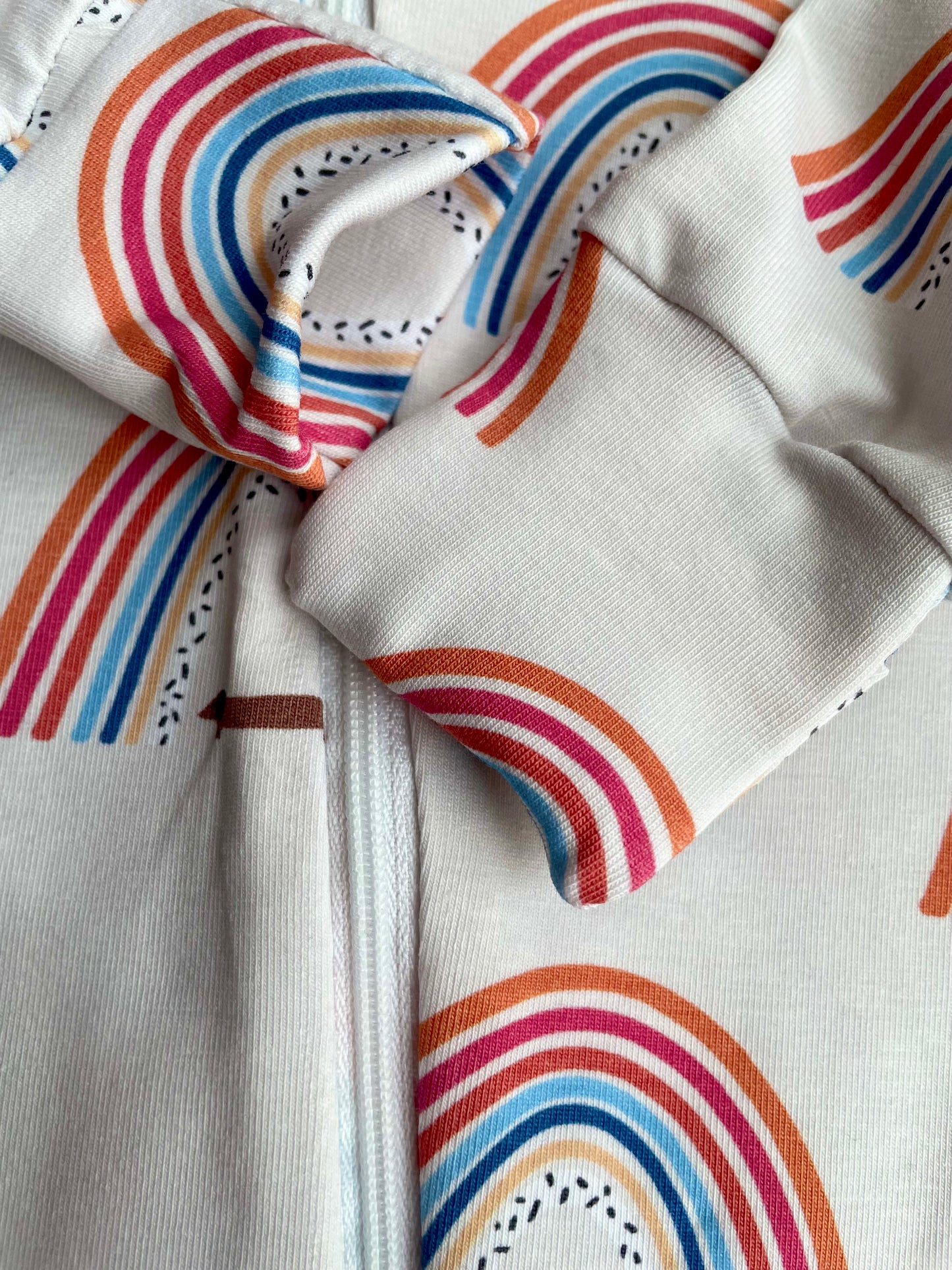 Sausage dog and rainbows zippy baby-grow