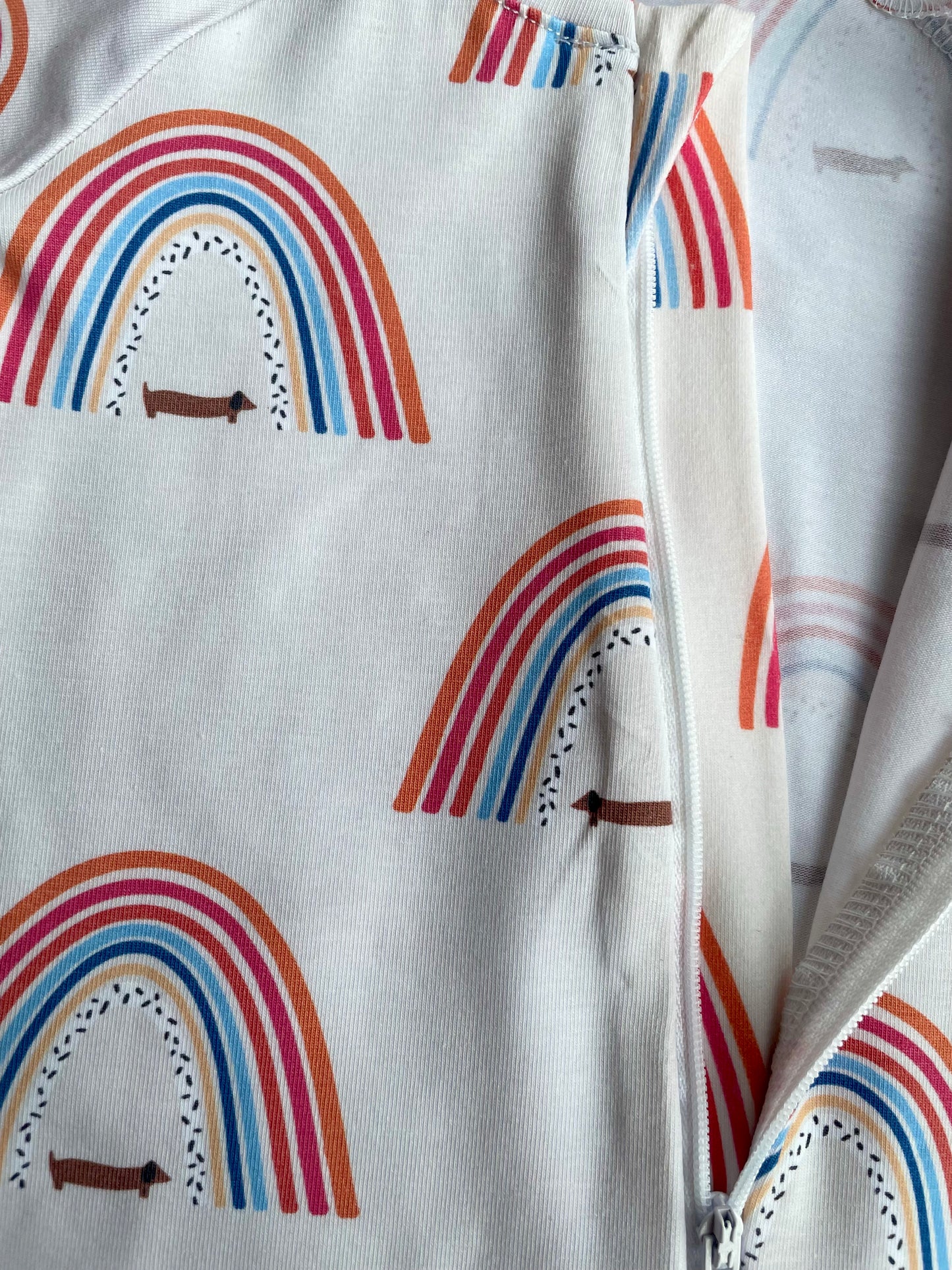 Sausage dog and rainbows zippy baby-grow