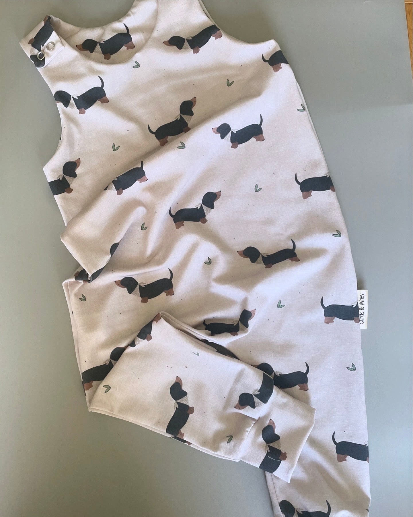 Eric Black and Tan sausage dog oatmeal romper