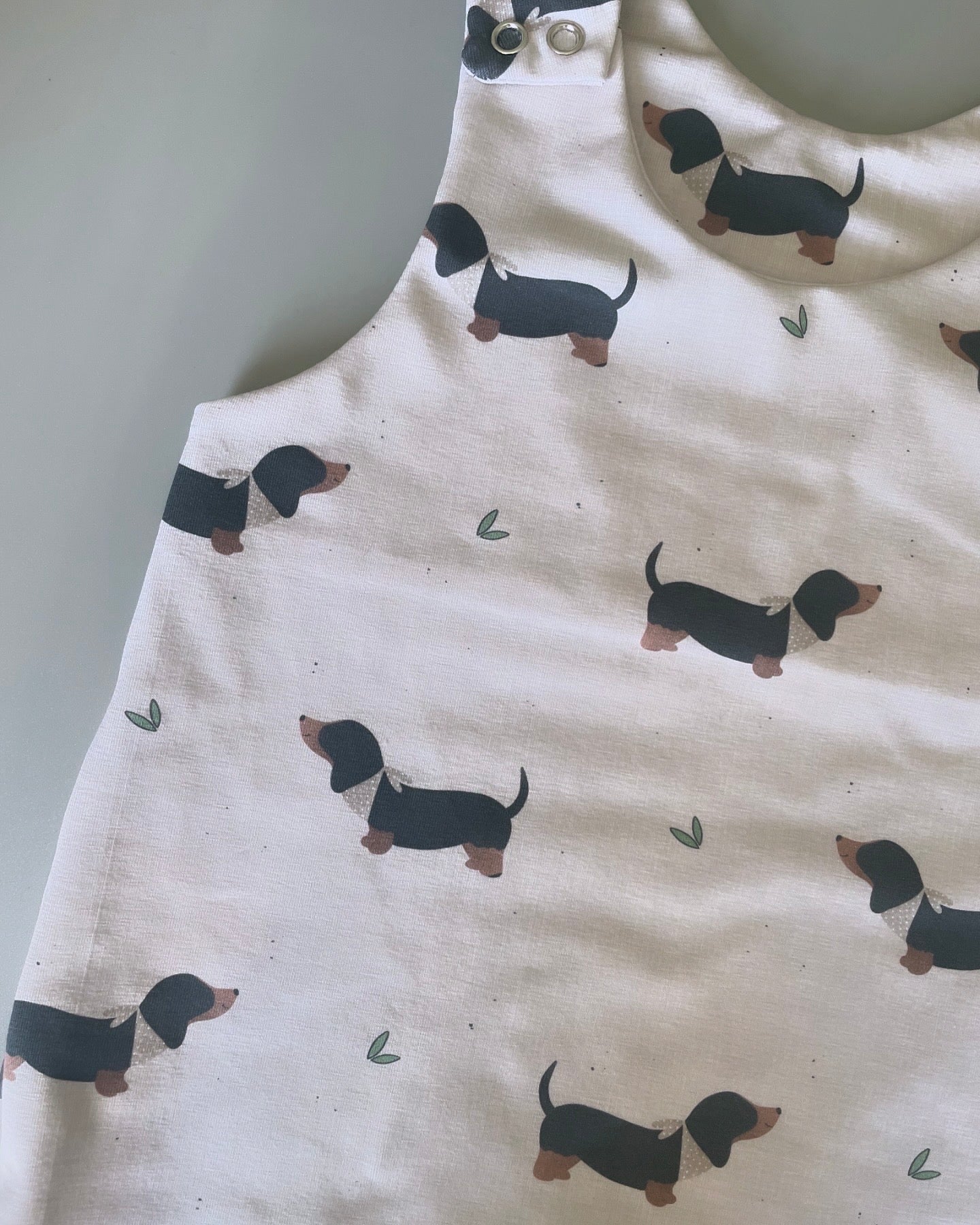 Eric Black and Tan sausage dog oatmeal romper